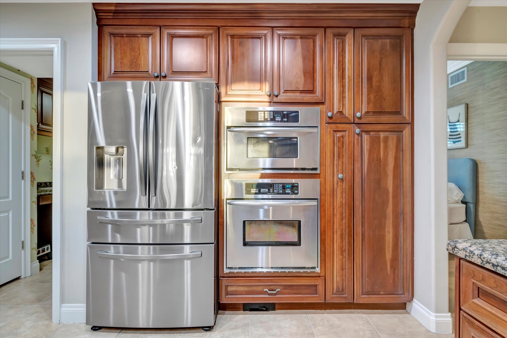 Your fully equipped kitchen features gleaming stainless-steel appliances and rich wood cabinetry, inviting you to prepare memorable vacation meals in comfort and style.