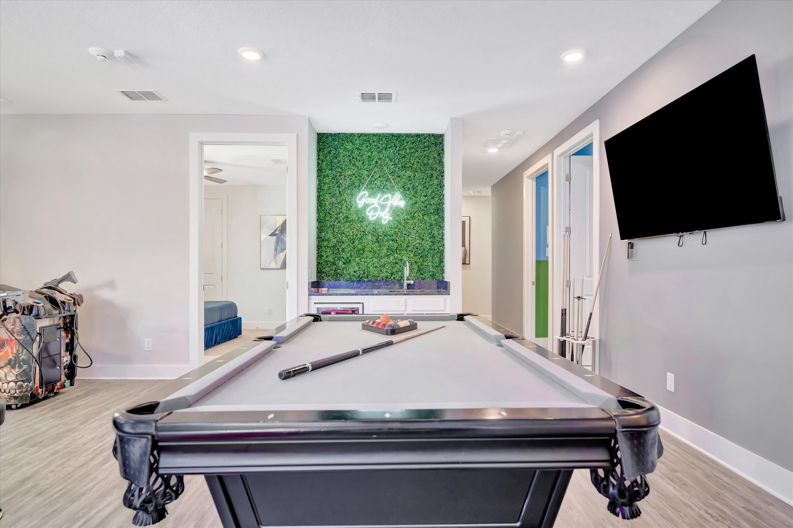 Challenge your crew to a game of pool in your private entertainment space, complete with a sleek pool table, big-screen TV, and vibrant neon accent—the perfect spot to unwind and have fun.