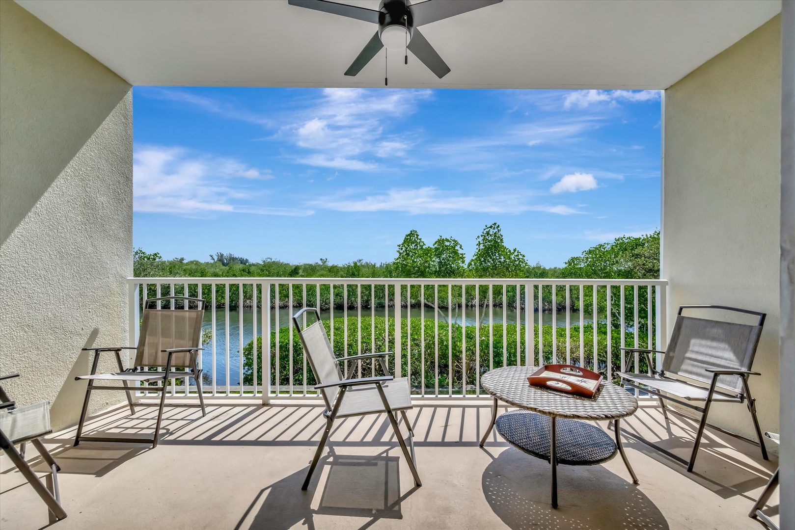 Unwind on your private balcony with comfortable seating and serene water views. The ceiling fan keeps you cool while you sip morning coffee or watch the sunset over the lush landscape.