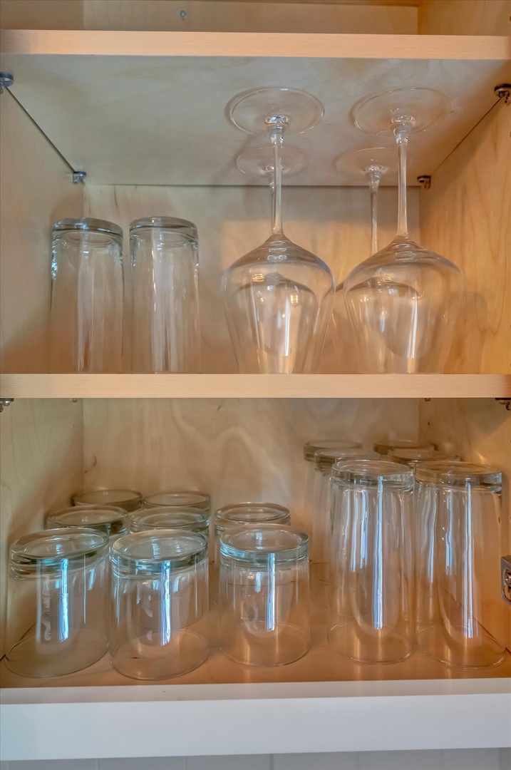 Open your kitchen cabinets to find everything you need for entertaining—stemware, glassware, and storage jars thoughtfully arranged and ready for your use.