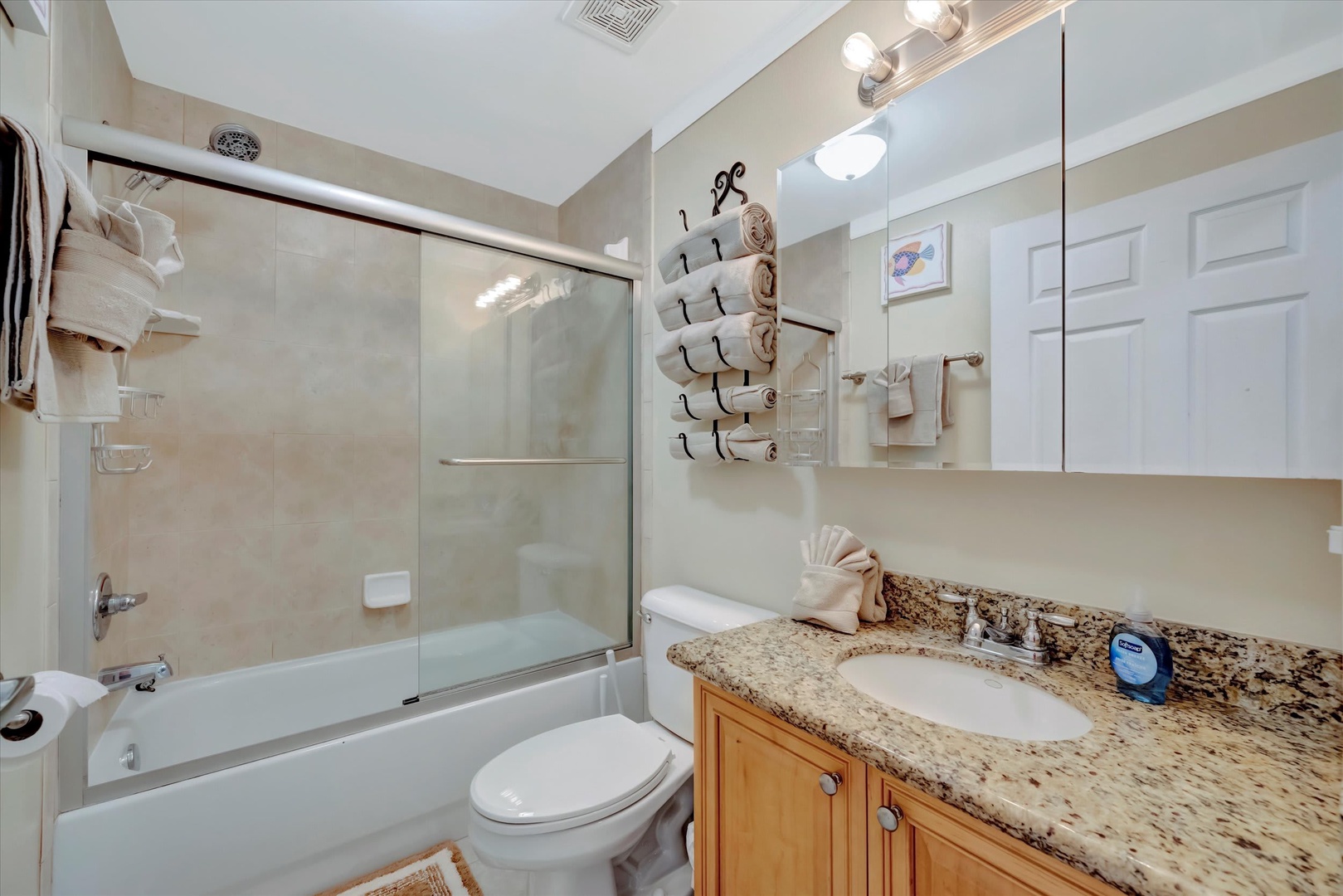 Step into your pristine bathroom, where soft neutral tones and granite countertops create a spa-like retreat. Fresh towels await, and the tub-shower combo promises a relaxing escape after your adventures.