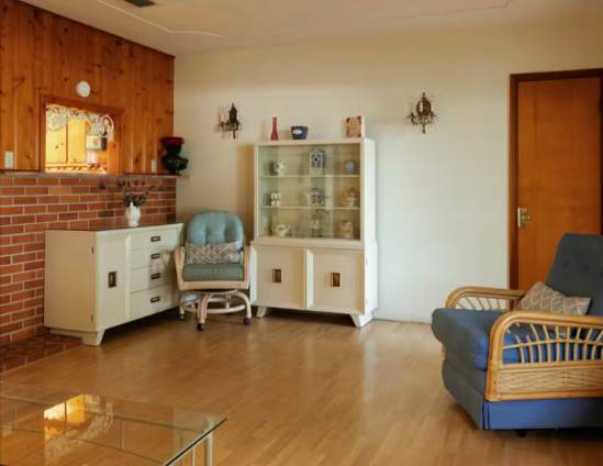 Step into your mid-century retreat where vintage charm meets comfort. Relax in the cozy seating area with retro rattan chairs, warm wood accents, and thoughtful décor that creates a welcoming home-away-from-home vibe.