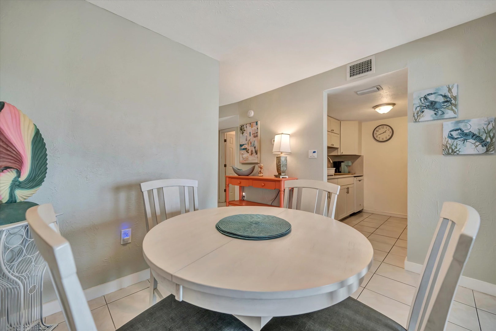 Gather at your dining table for meals and conversation, with the full kitchen just steps away and cheerful coastal touches throughout.