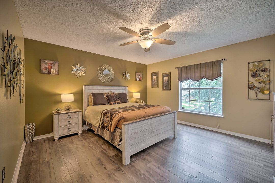 Relax in your peaceful bedroom retreat with soothing colors, elegant decor, and warm natural light streaming through the window to welcome each morning.