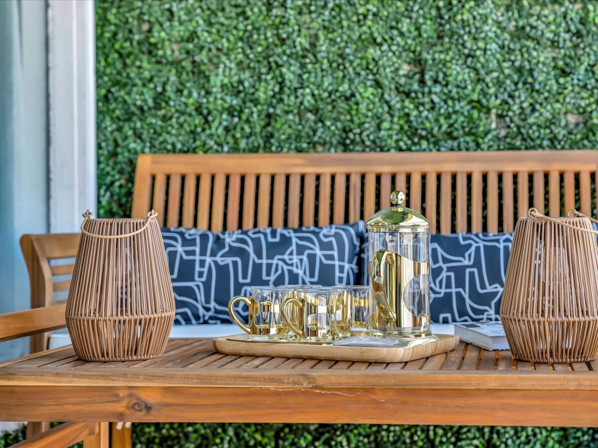 Start your morning with fresh coffee in this peaceful outdoor setting. Warm wood tones and soft lantern light create an inviting space where you can unwind and savor the moment.