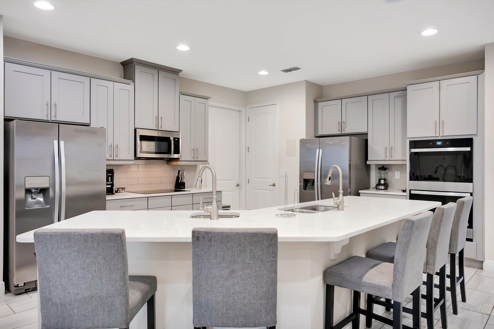 Your culinary hub awaits—gleaming countertops, modern appliances, and a welcoming breakfast bar where you can sip morning coffee or gather with loved ones for casual meals.