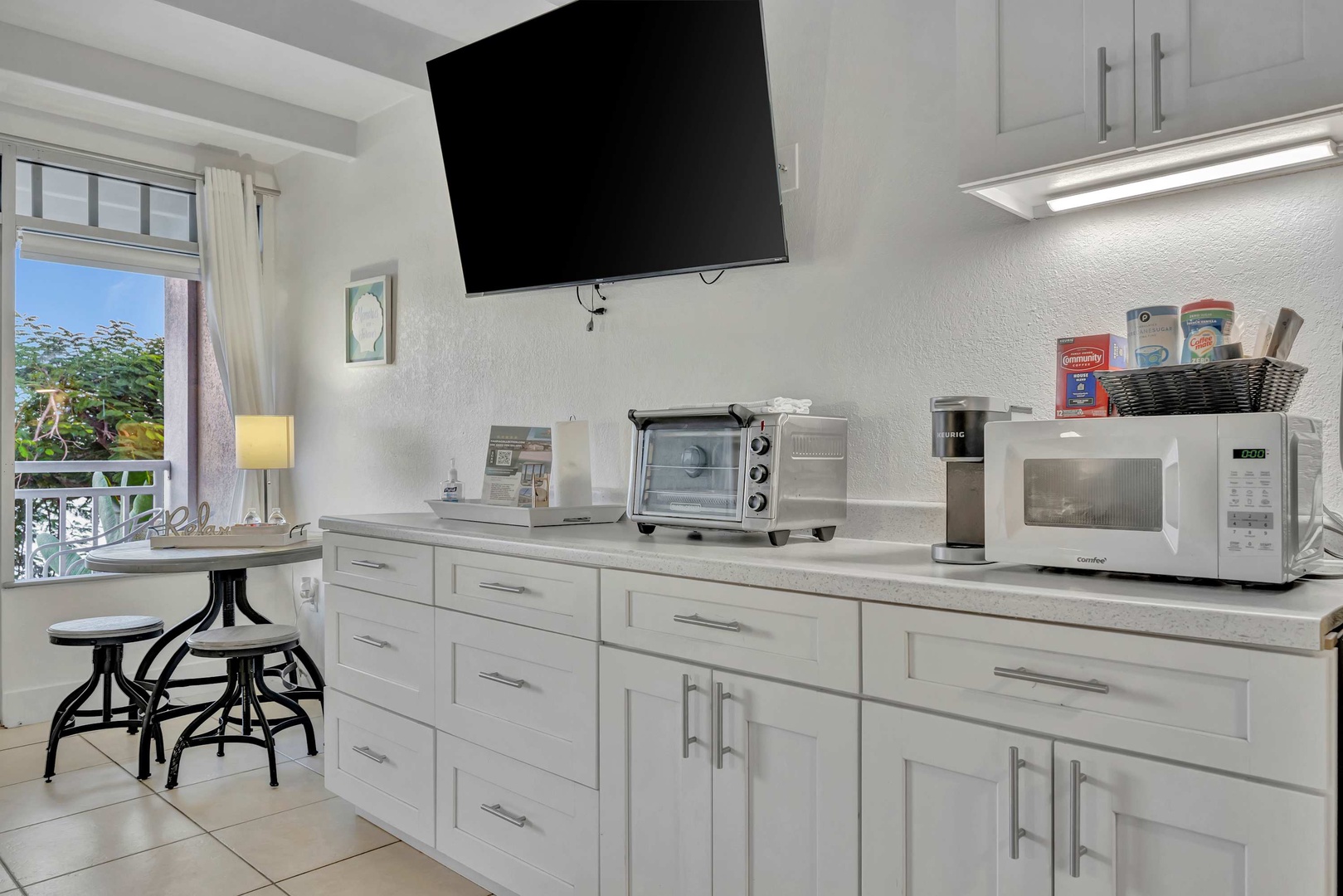 Your well-equipped kitchenette features everything you need to prepare meals, including a microwave, toaster oven, and coffee maker. Enjoy your morning coffee at the bistro table while taking in the tropical garden view.