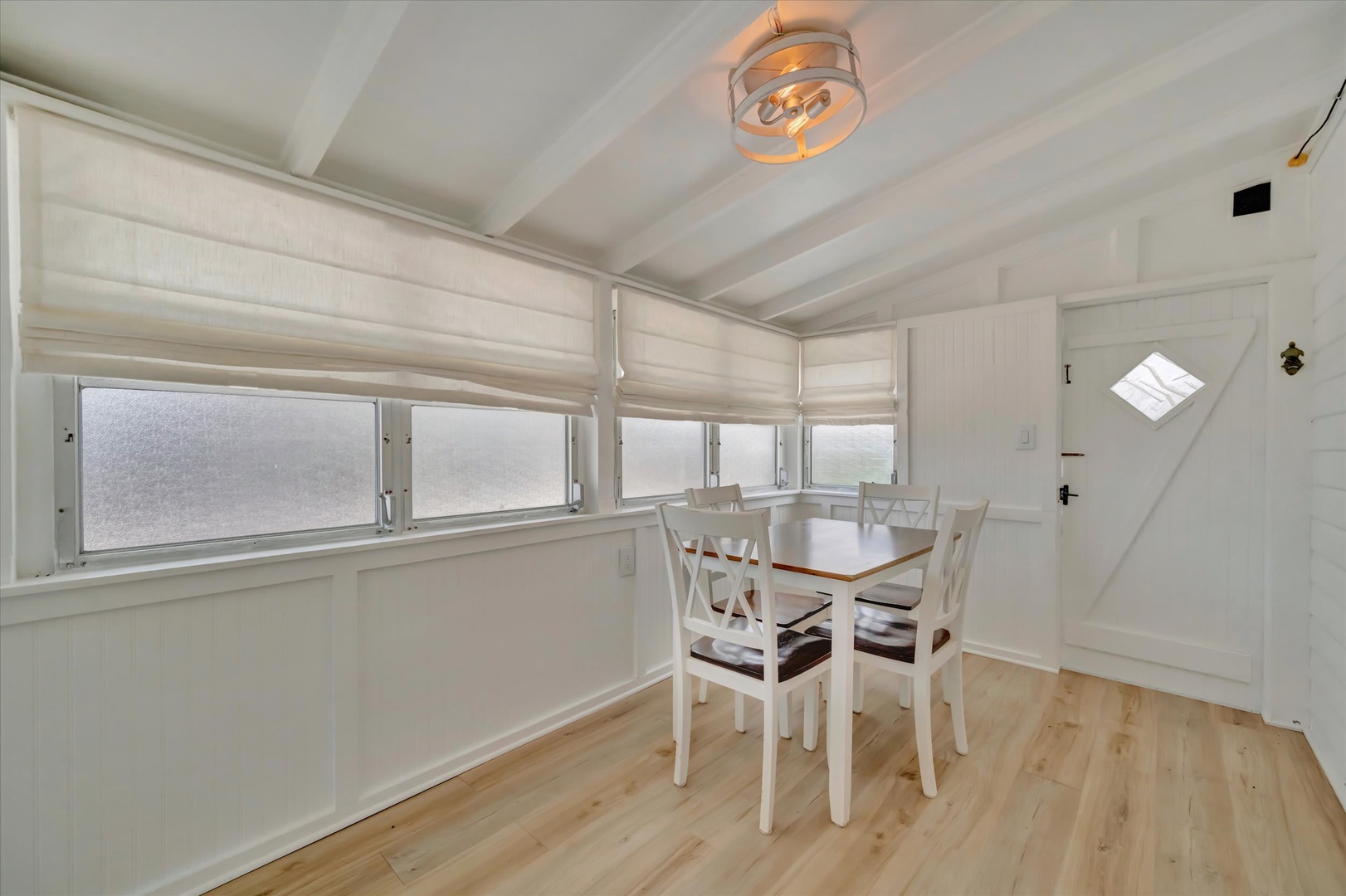 Gather around this cozy dining space where natural light fills the room and your favorite meals are just steps away from the kitchen.
