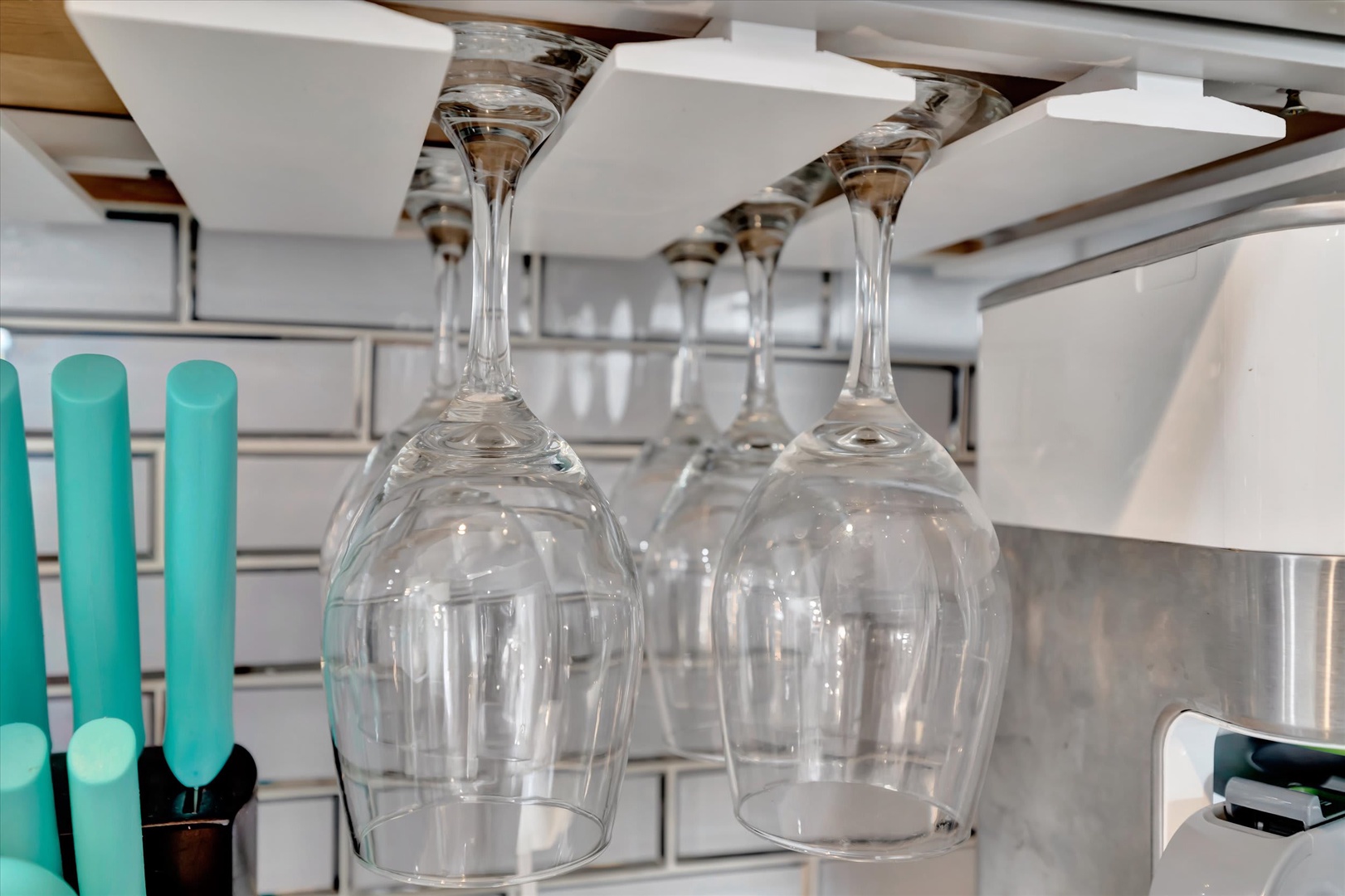 Smart storage solutions keep your glassware organized and within easy reach, making entertaining effortless during your stay.