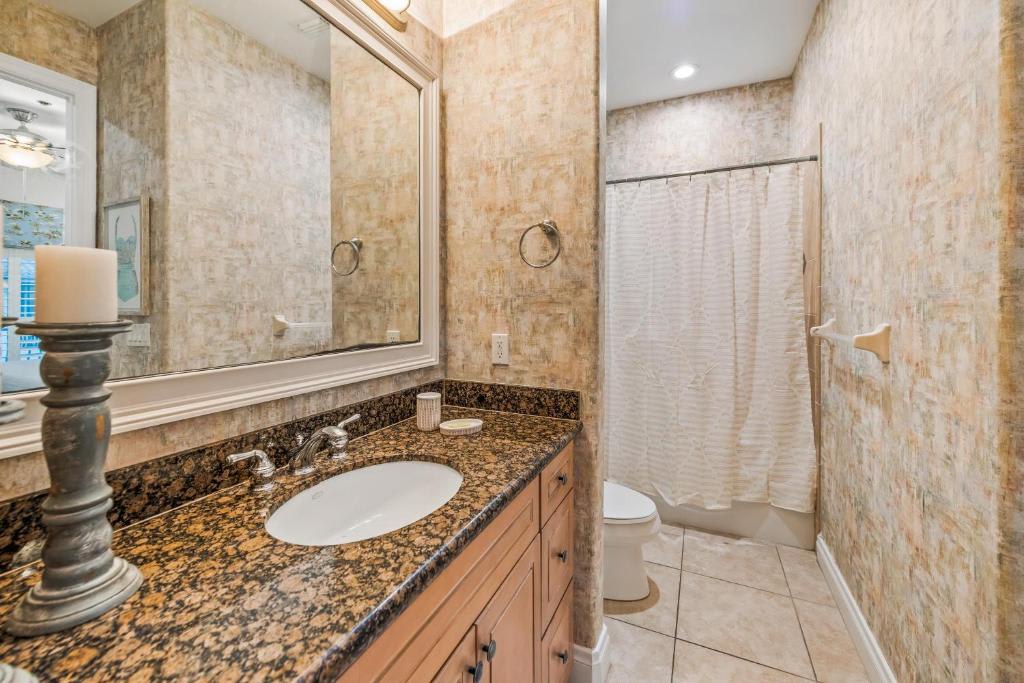 Your private bathroom features warm stone-look tile, granite countertops, and a convenient walk-in shower with a relaxing rainfall head—perfect for unwinding after a day of adventures.