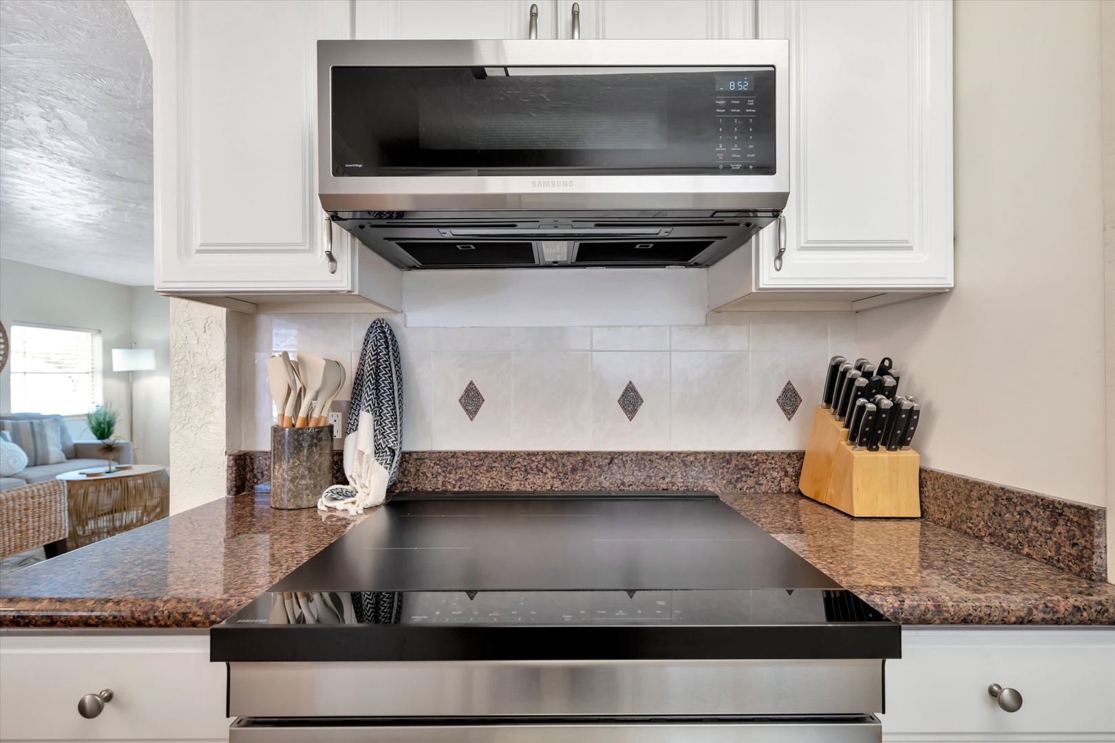 Your home away from home features a fully equipped kitchen with modern appliances and granite countertops, ready for preparing meals at your convenience.