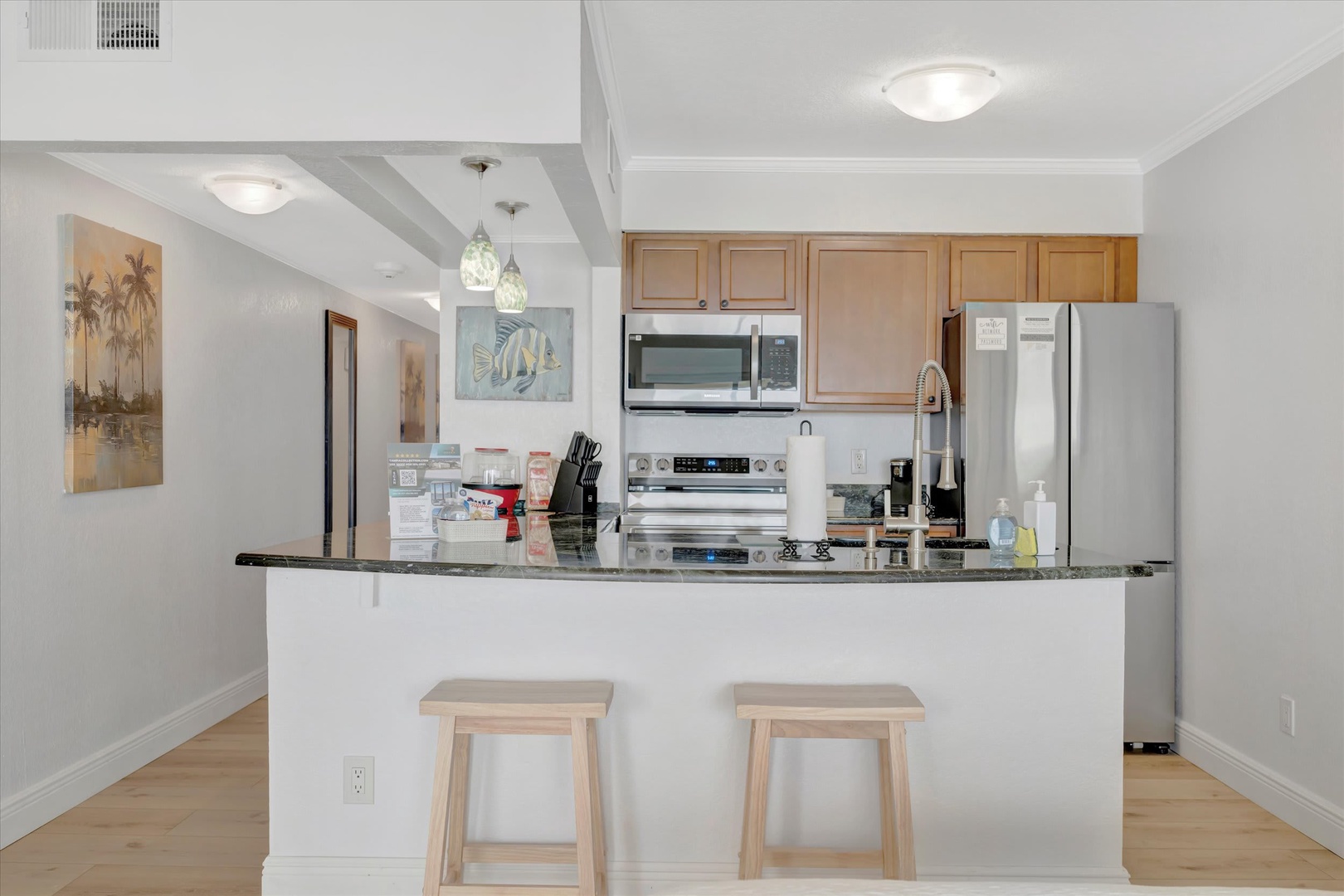 Step into your bright, open kitchen with sleek granite counters, modern appliances, and a breakfast bar perfect for morning coffee or casual meals.