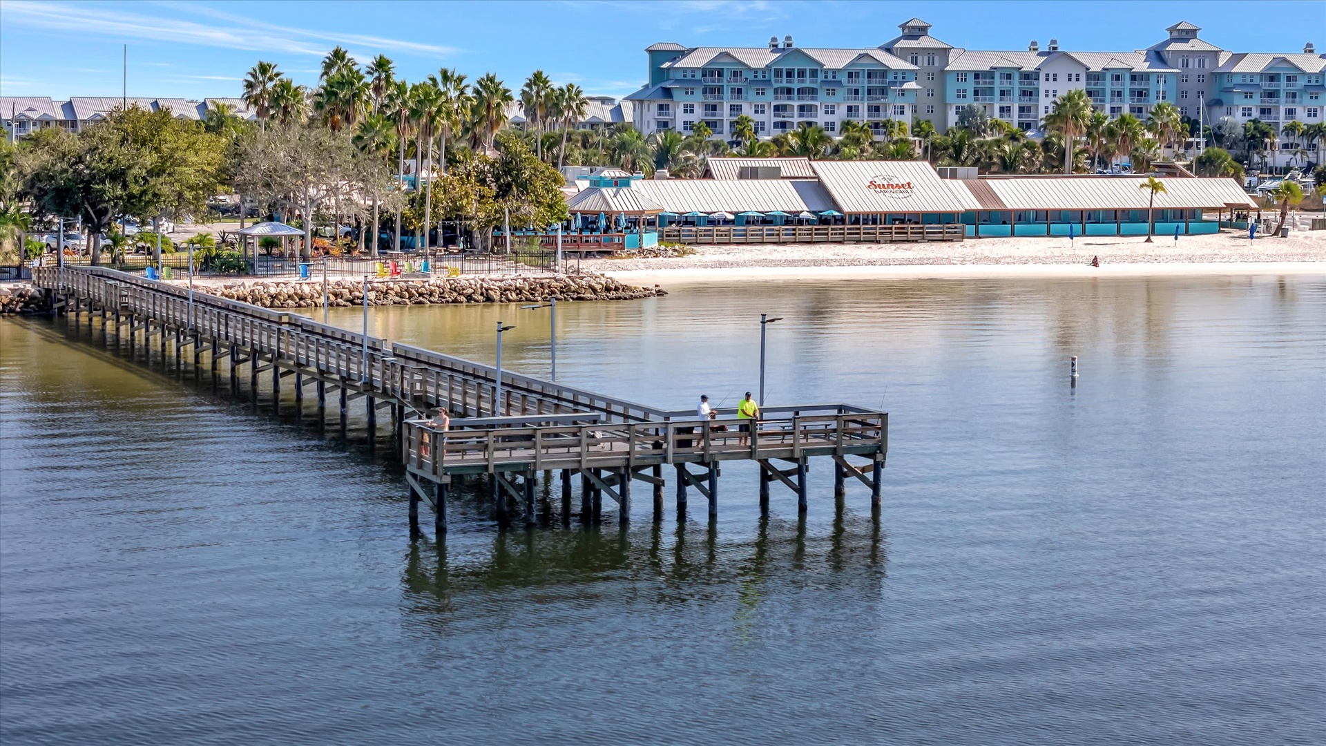This waterfront resort features a fishing pier extending into calm waters, with palm-lined shores and nearby restaurants. The coastal location offers easy access to beaches and local attractions throughout your stay.