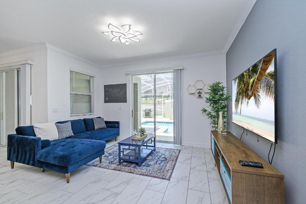 Sink into plush blue sofas and unwind in your bright, open living space. The view through sliding doors invites you to the pool, while modern touches and calming tones make this the perfect place to relax after a day of adventure.