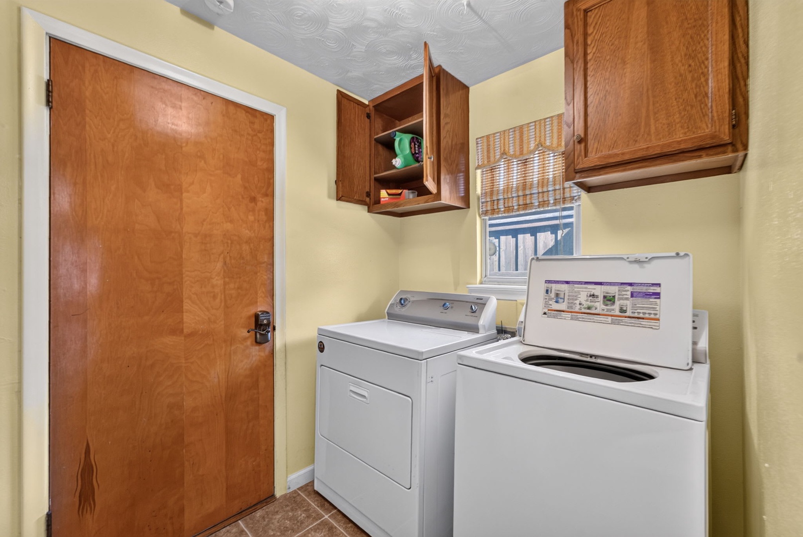 Keep your wardrobe fresh and travel light with your own in-home laundry setup featuring a full-size washer and dryer, plus handy cabinet storage for supplies.