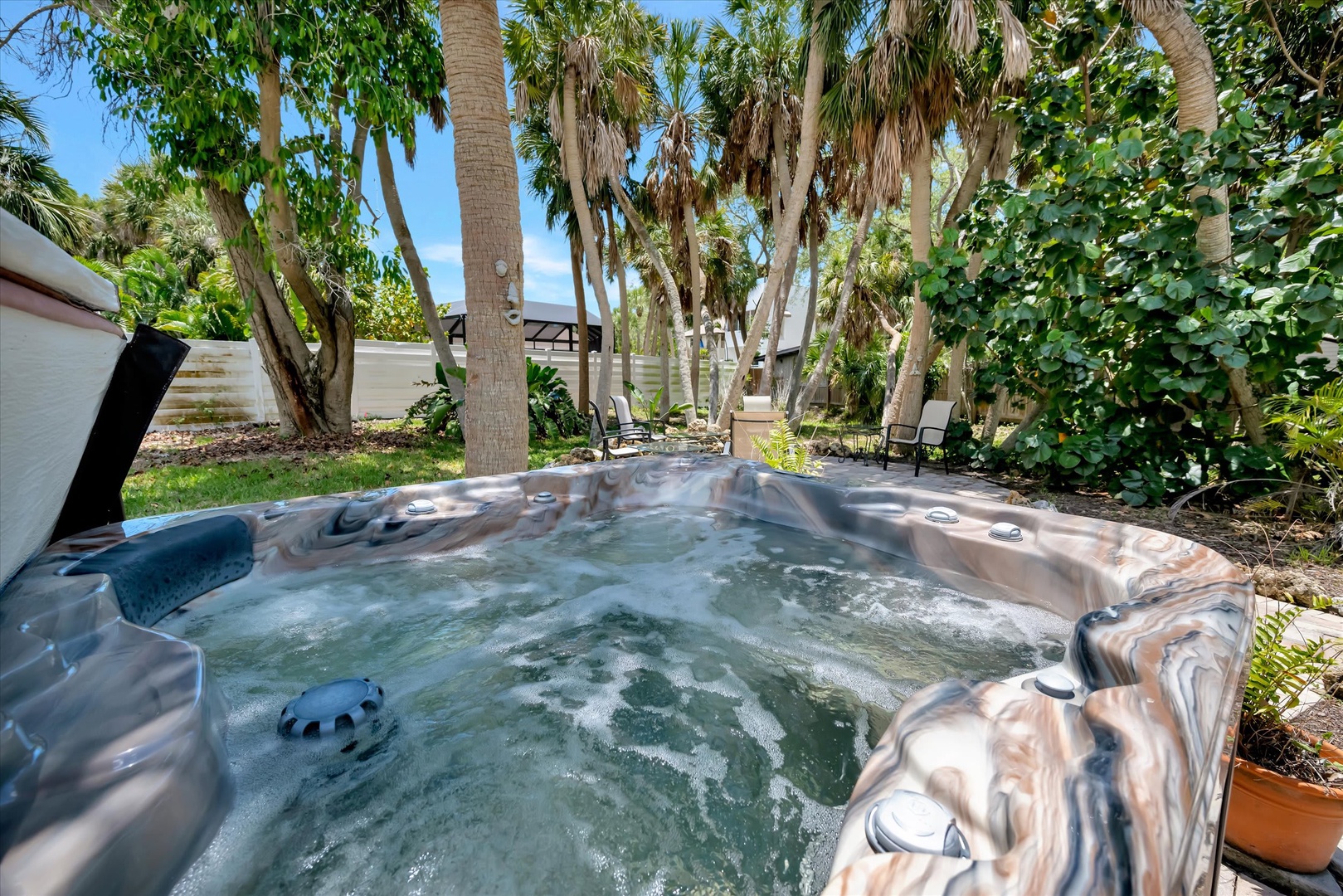 Soak away your cares in your private hot tub, nestled beneath swaying palms and lush tropical greenery. The perfect spot to unwind after a day exploring.