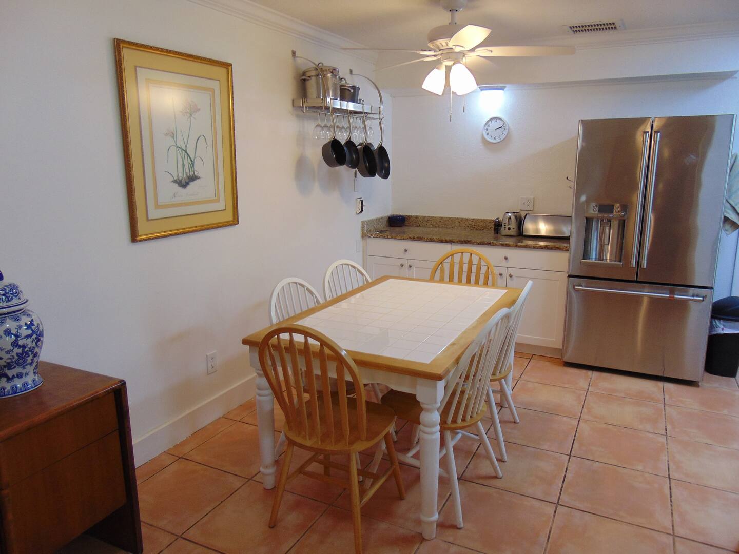 Gather around the dining table in your well-equipped kitchen, where granite countertops, stainless steel appliances, and a cheerful breakfast nook invite you to prepare and savor home-cooked meals together.