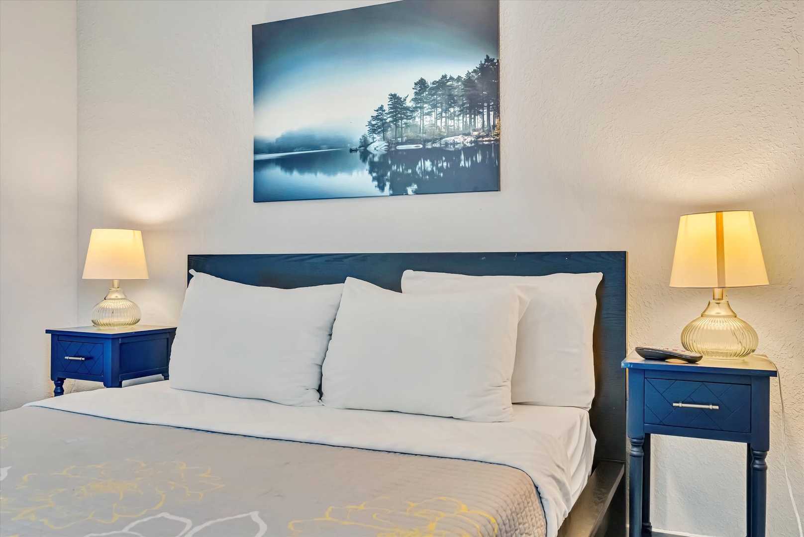 Settle into crisp linens and let the soft glow of bedside lamps ease you into a restful night in your inviting bedroom retreat.