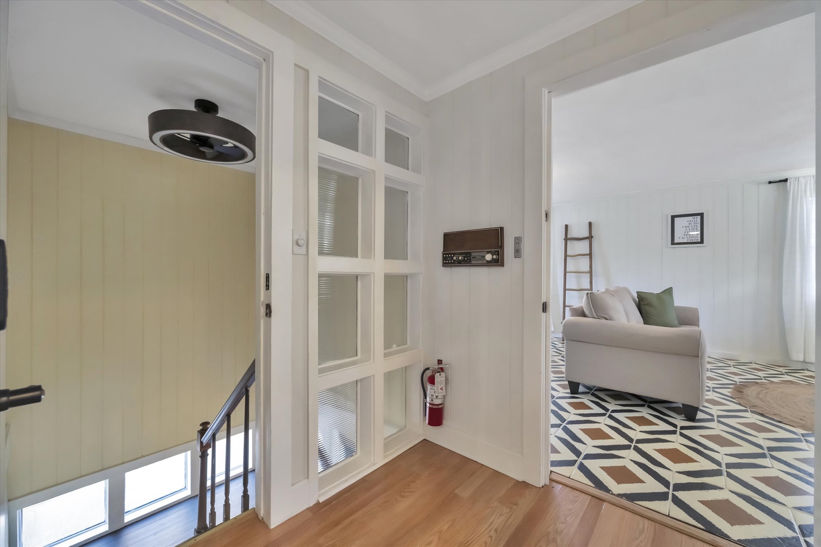 Step into this thoughtfully designed space with clean lines and calming tones that invite you to feel right at home. Notice the geometric floor tiles leading you through bright, open rooms.