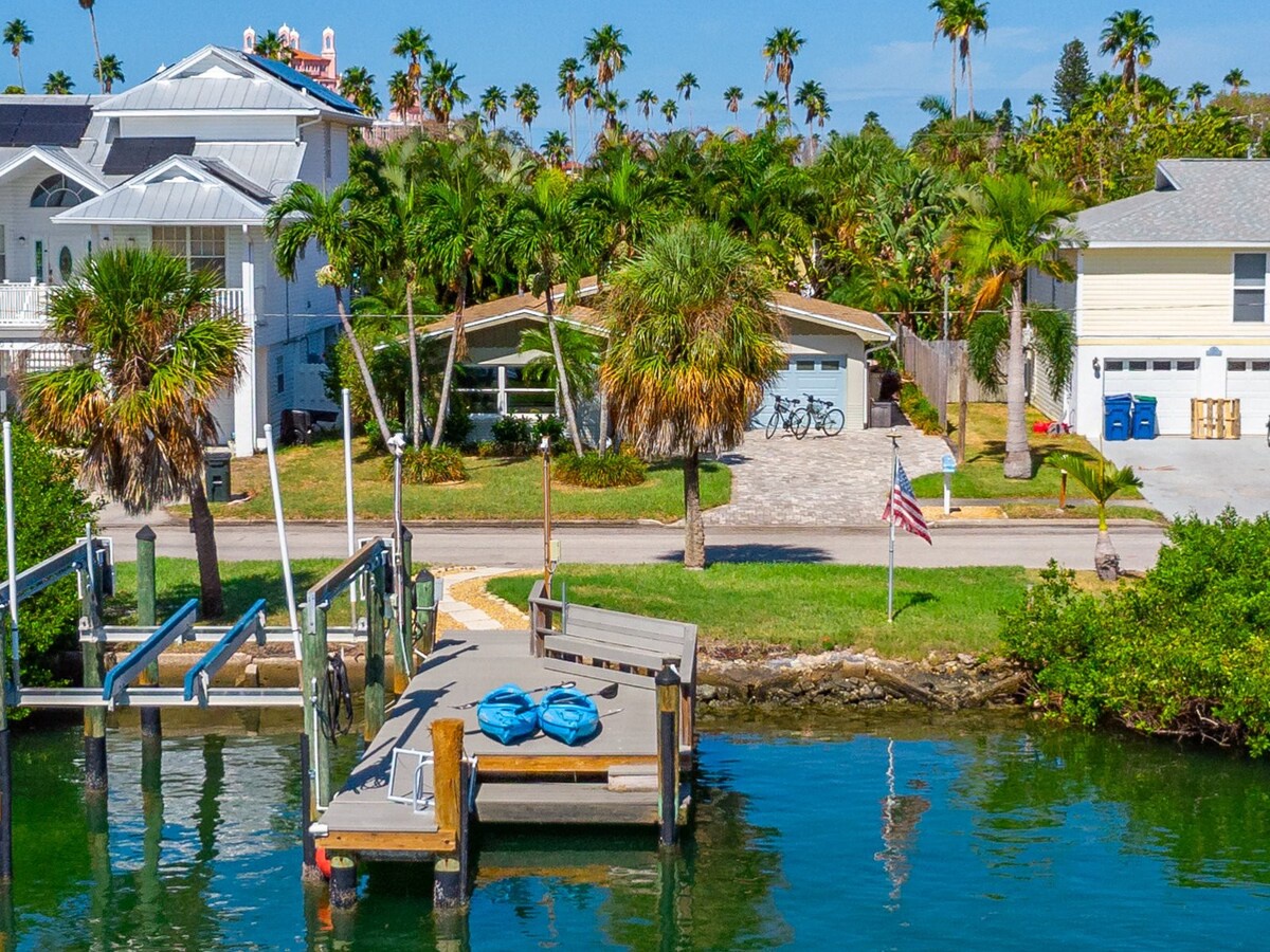 A waterfront coastal neighborhood with tropical palms and private boat dock access. The property sits along a peaceful canal, offering an ideal setting for fishing, kayaking, or simply soaking in the Florida sunshine.