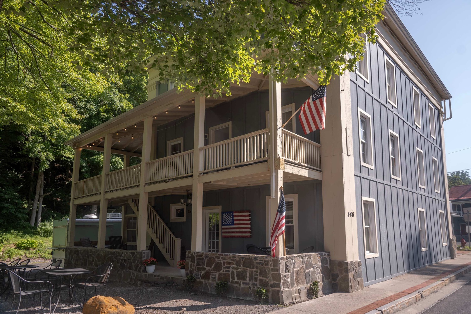 This charming property features a distinctive multi-level facade with expansive covered balconies, blending historic character with modern comfort in a picturesque neighborhood setting.