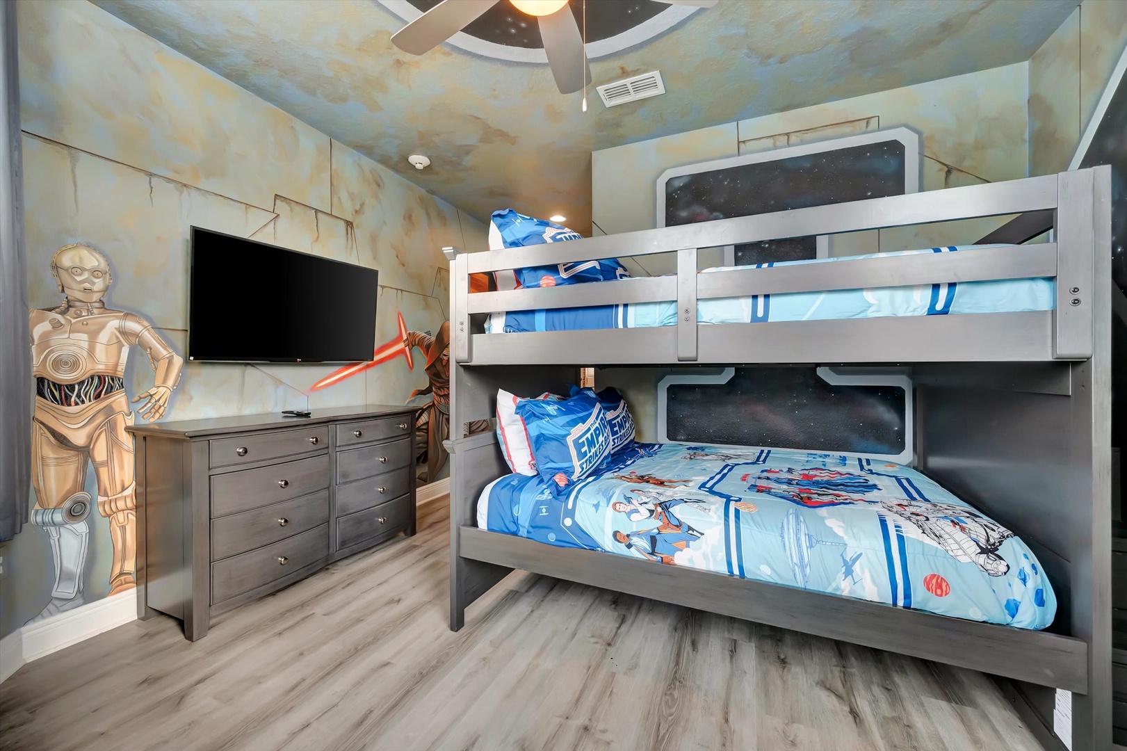 Step into a galaxy far, far away in this themed bedroom with custom bunk beds and space-age décor that'll make bedtime an adventure for your young explorers.