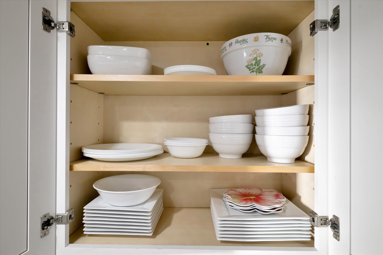 Your fully stocked kitchen cabinet awaits, complete with elegant dishware and serving pieces for every meal you'll enjoy here.