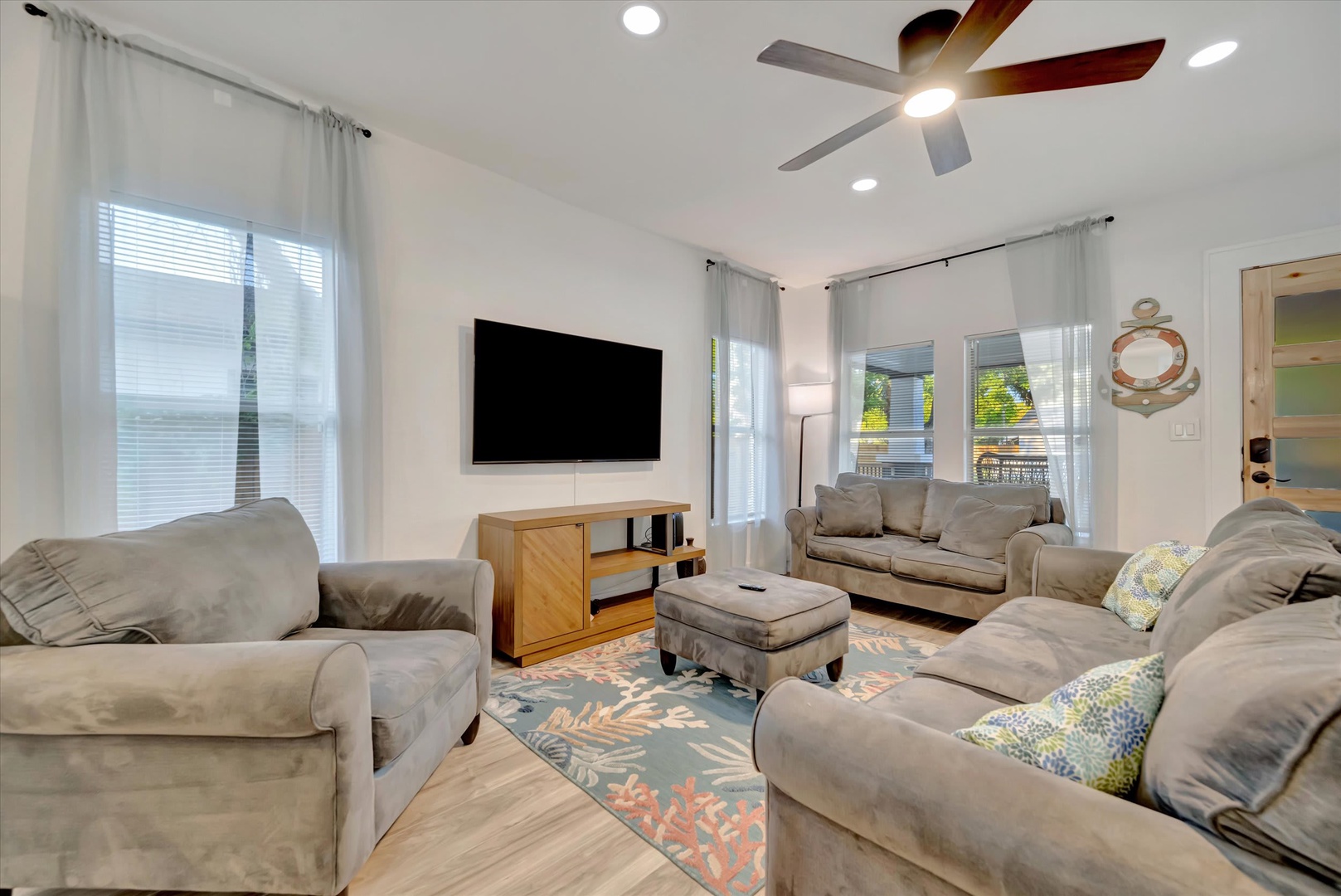 Sink into plush seating and unwind in your bright living room—perfect for streaming your favorites or simply enjoying the airy coastal vibe.