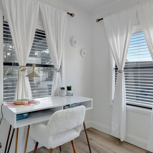 Step into your bright, serene workspace where natural light pours through tall windows, inviting focus and calm. Soft curtains frame your views, and the minimalist desk gives you room to breathe, create, and unwind.