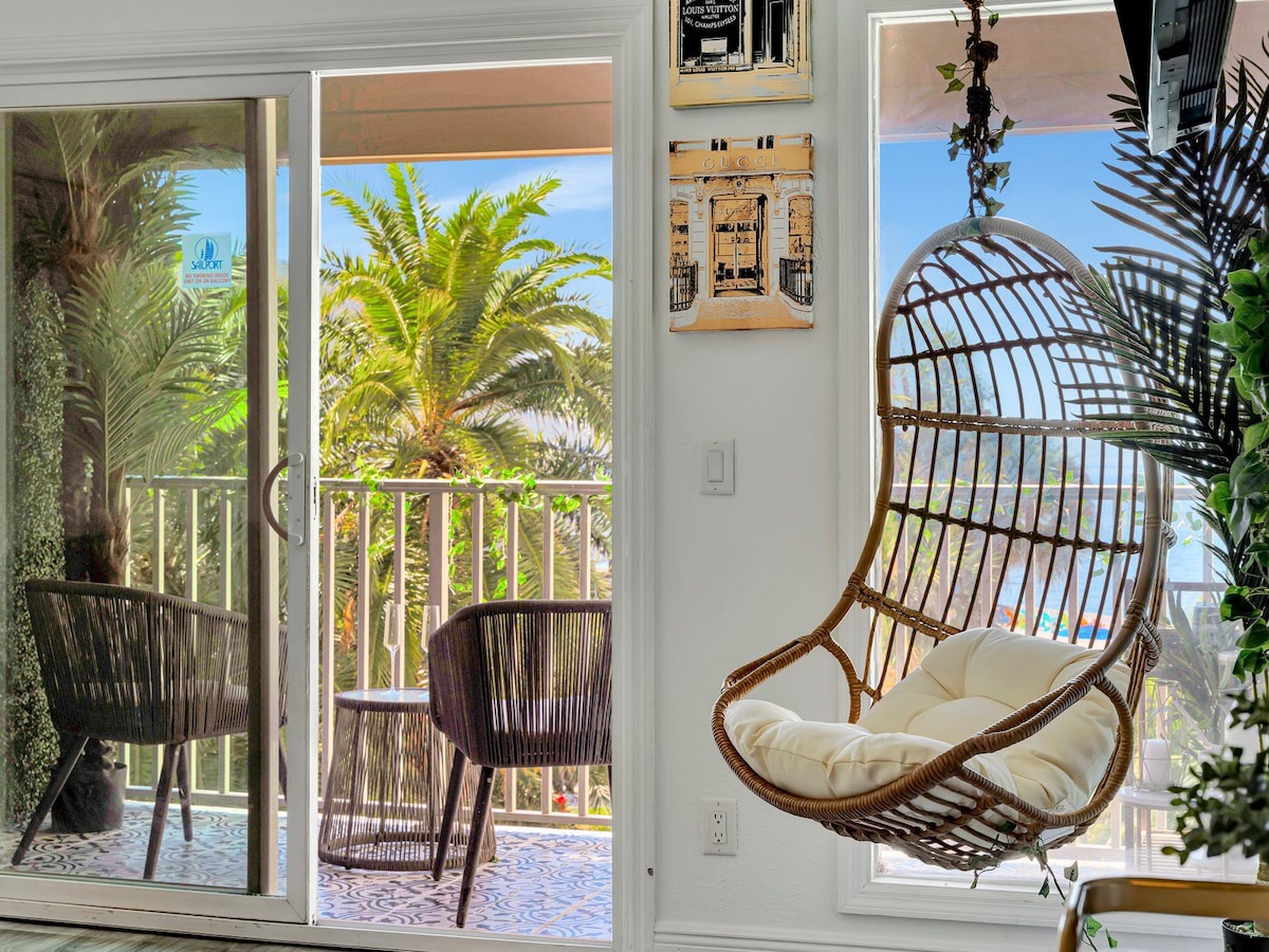 Curl up in your cozy hanging chair and let the tropical ocean breeze drift through the open balcony doors—your personal escape awaits.