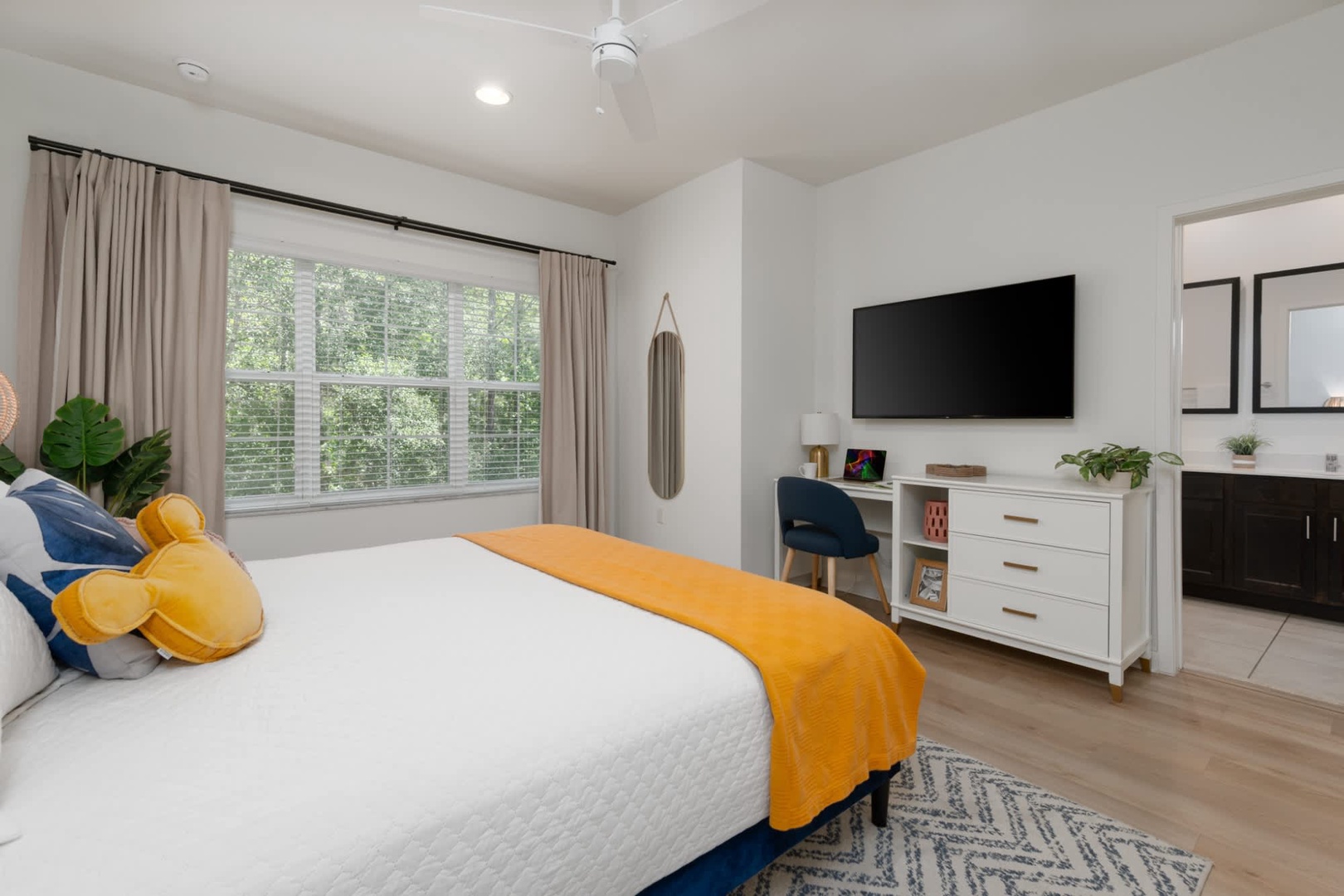 Sink into comfort with crisp linens and a cheerful pop of color, while leafy views through the window invite you to unwind after your adventures.
