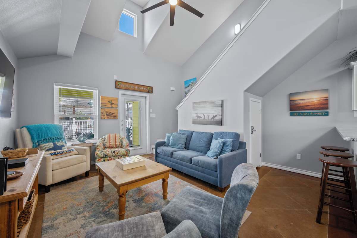 Step into your bright, airy living space where vaulted ceilings and coastal charm welcome you home. Sink into the plush seating, feel the natural light pour through, and let vacation mode begin.