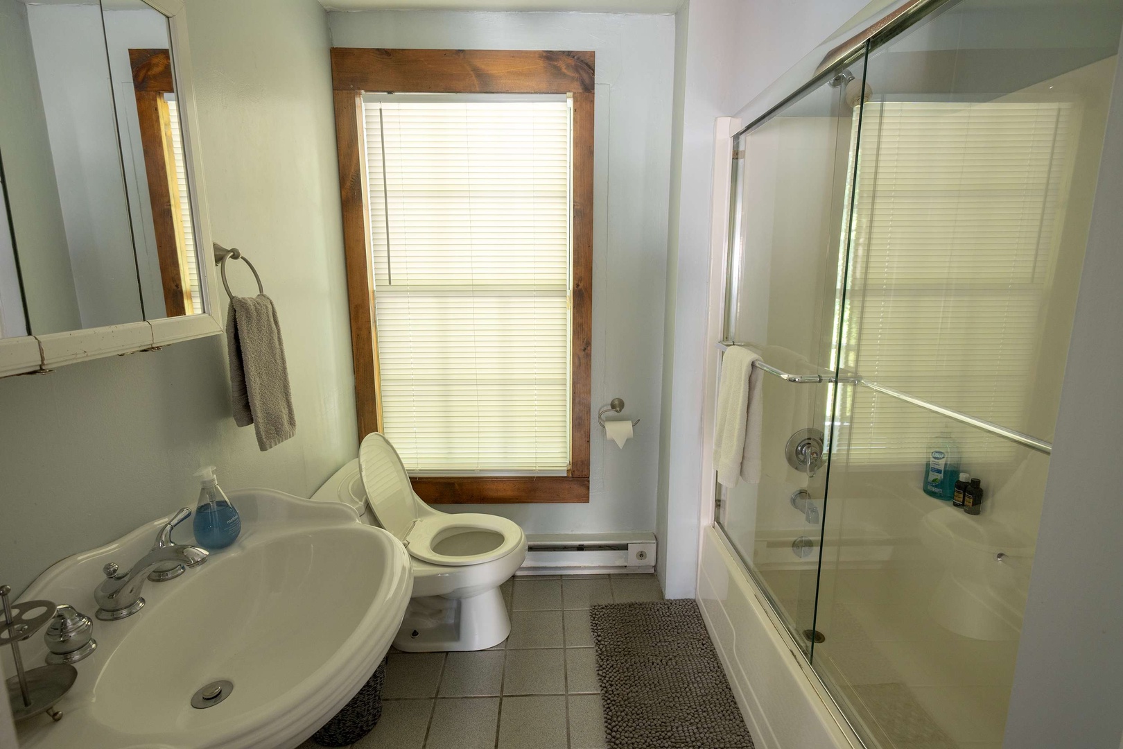 Your private bathroom offers everything you need to freshen up—a roomy shower with glass doors, plus a window that lets in plenty of natural light.