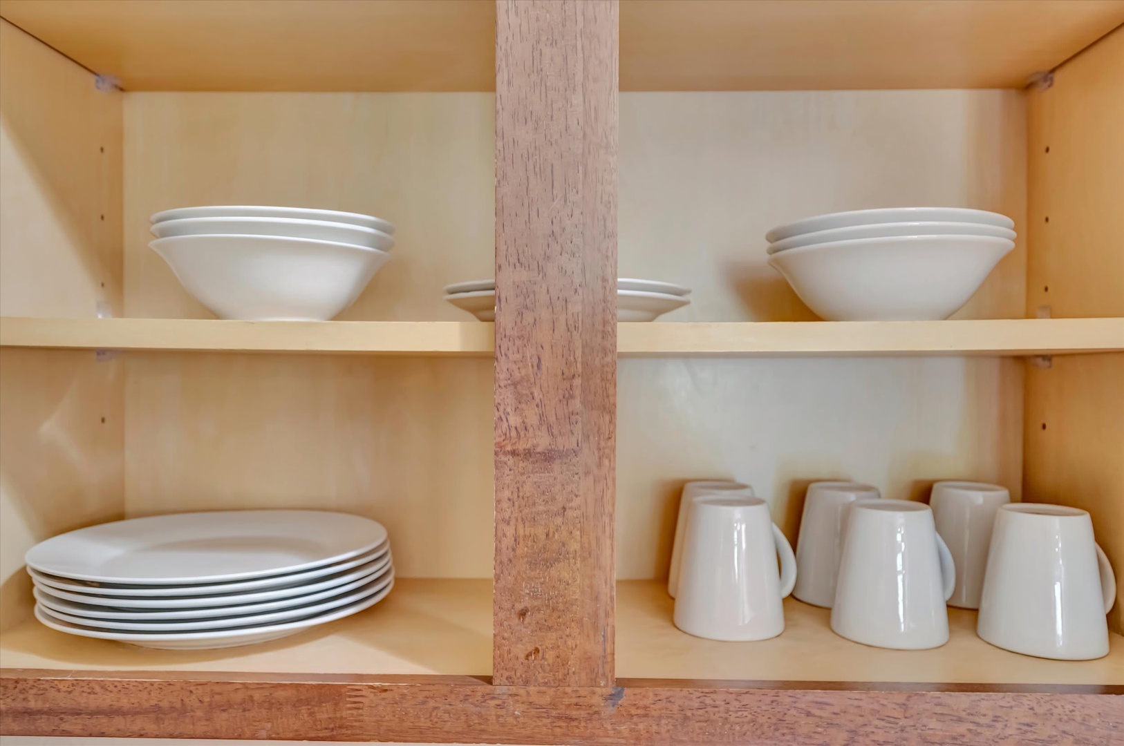 Open shelving displays crisp white dishes and mugs, keeping your kitchen essentials within easy reach for effortless meal prep and entertaining.