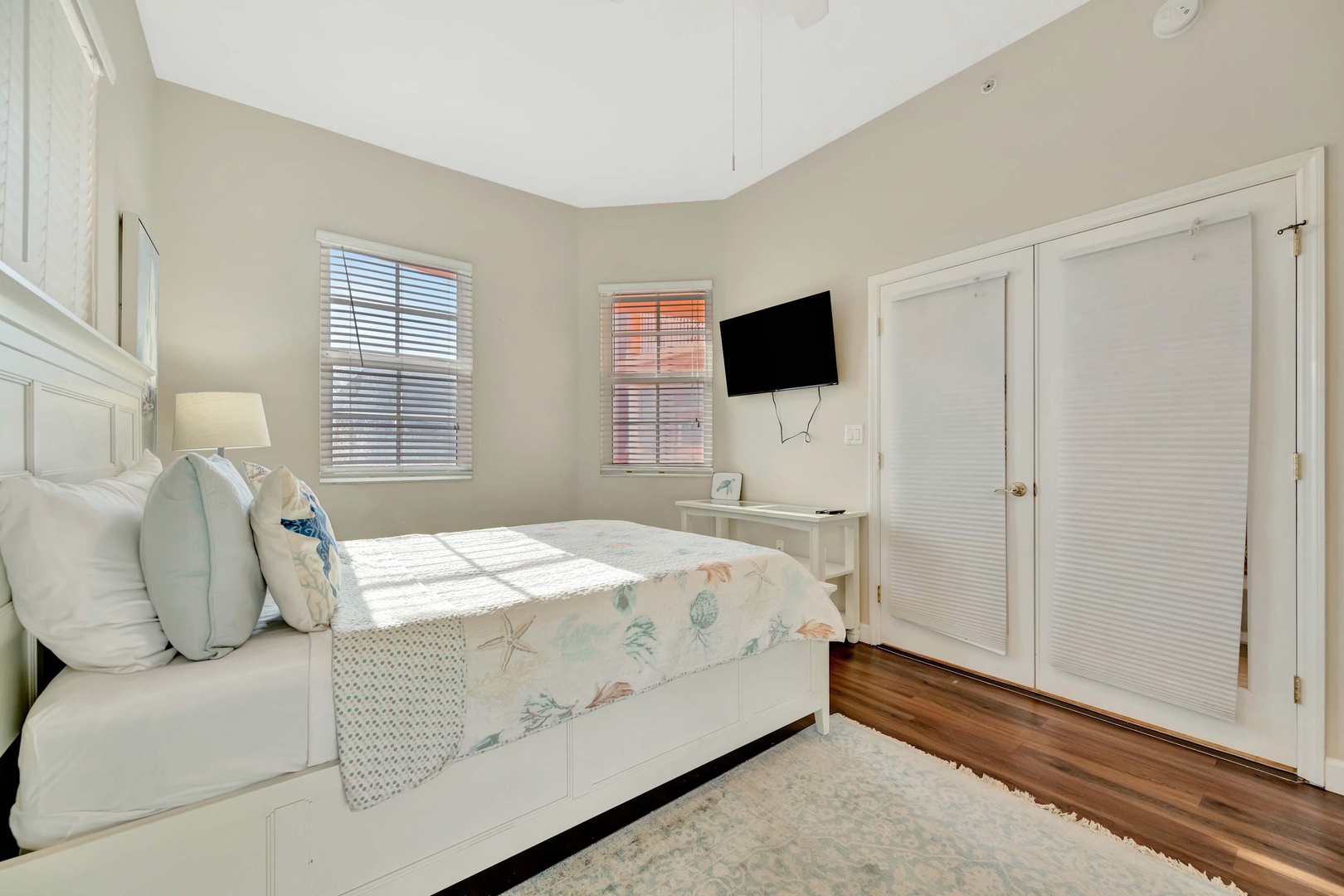 Drift off in this peaceful bedroom where natural light streams through coastal-inspired shutters and soft linens invite you to unwind in style.