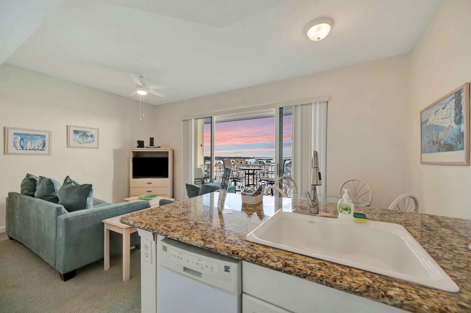 Step into your coastal haven where granite countertops gleam and your living space opens to a breathtaking sunset view over the water. The open-concept layout lets you unwind in comfort while soaking in the evening's golden glow.