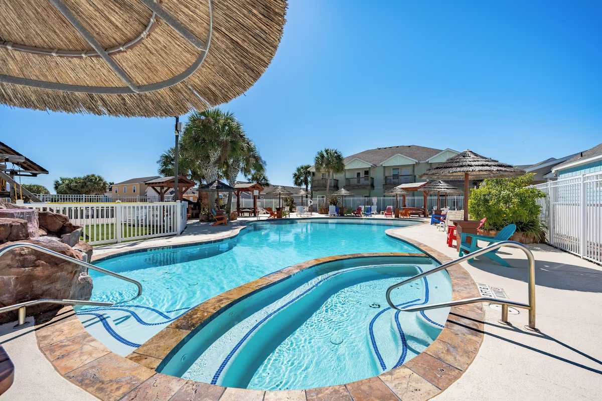 Relax under the shade of a thatched palapa as you enjoy sparkling turquoise waters and warm coastal breezes—your perfect getaway awaits poolside.