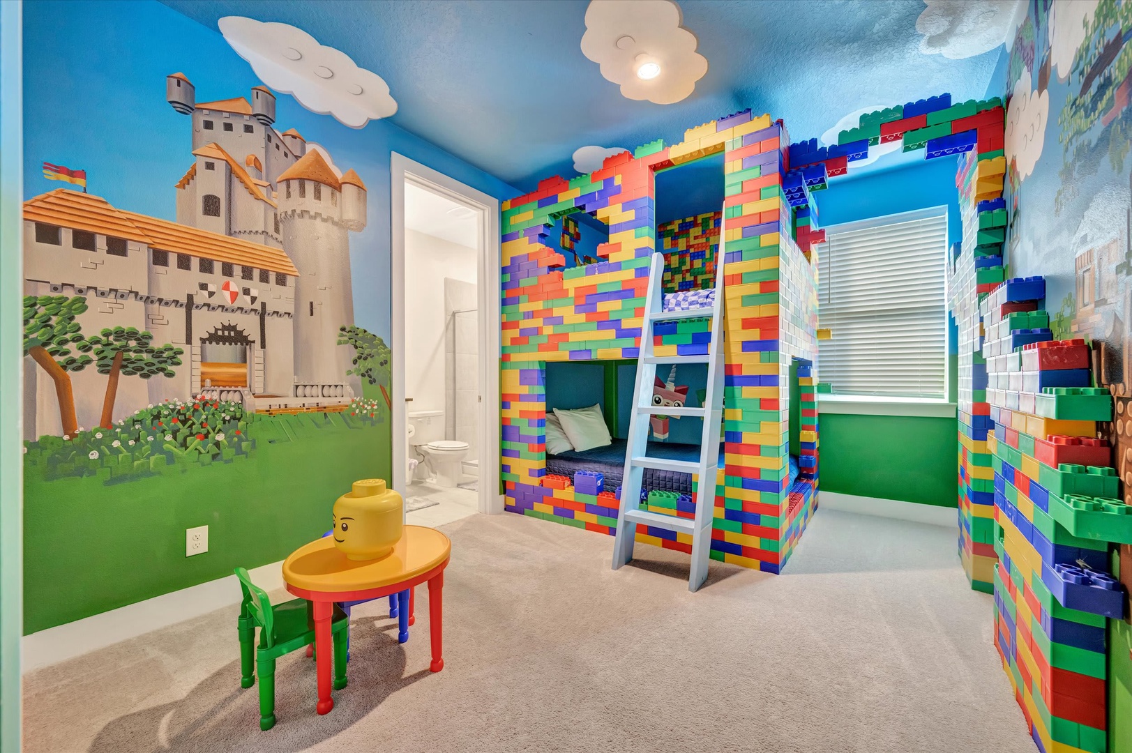 Your little ones will love this whimsical bedroom where colorful brick-style bunk beds spark imagination and playful castle murals transport them to a world of adventure and fun.