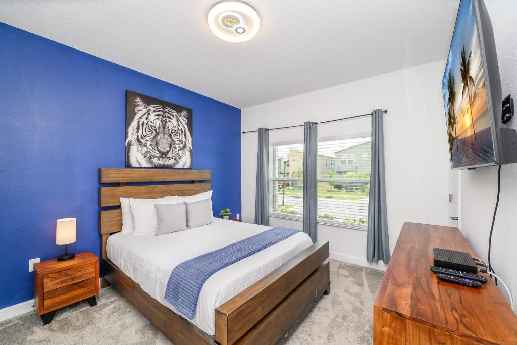 Sink into crisp white linens in your modern bedroom, where a bold blue accent wall sets a calming tone for restful nights and bright mornings filled with natural light.