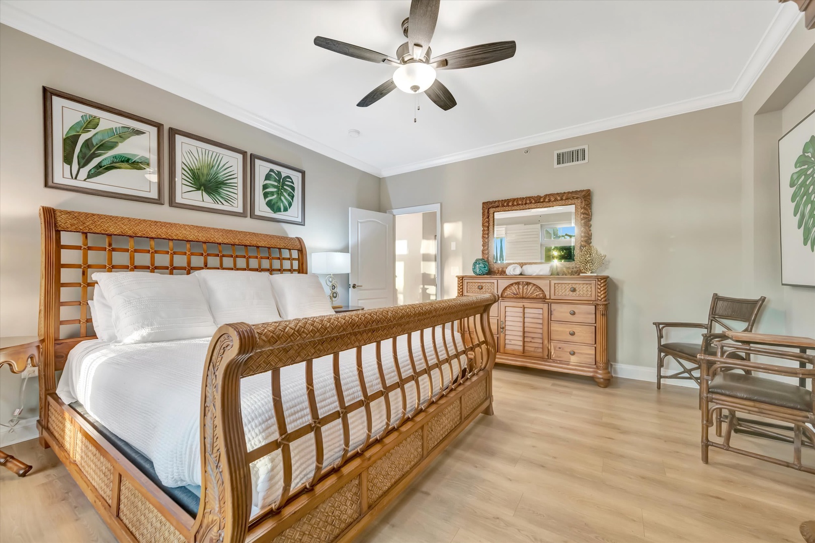 Step into your tranquil bedroom retreat, where coastal charm meets comfort. The plush bed, tropical touches, and gentle ceiling fan breeze create your perfect island-inspired escape.