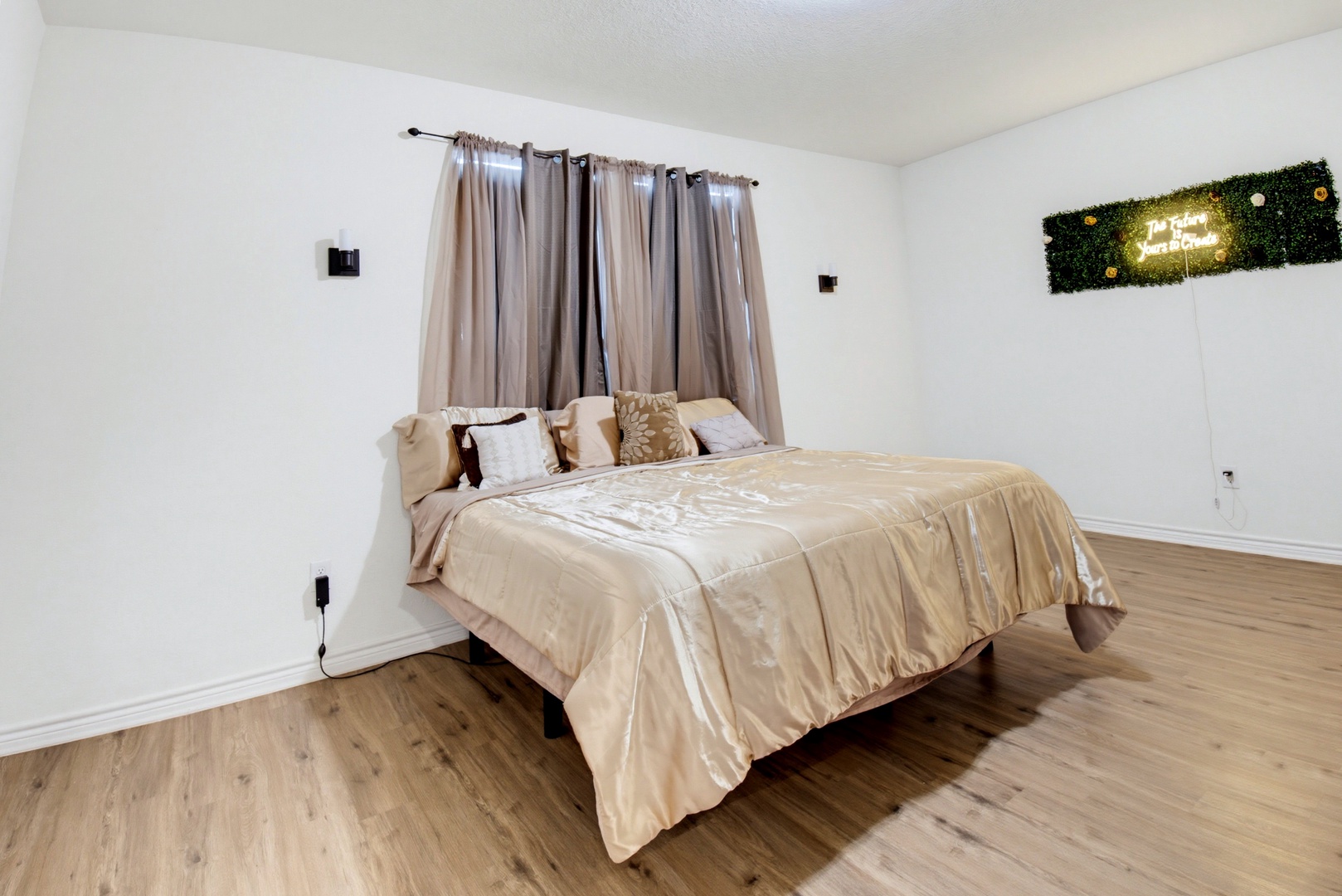 Sink into plush linens and let the soft glow of the welcoming wall art set the mood for your perfect night's rest in this serene retreat.