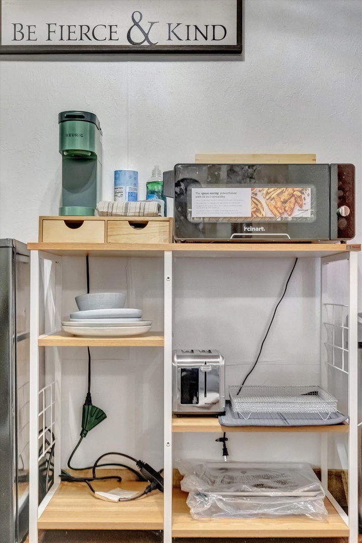 Your morning coffee station is fully stocked with a Keurig brewer, mugs, plates, and even a toaster for light snacks—everything you need to start your day at your own pace.