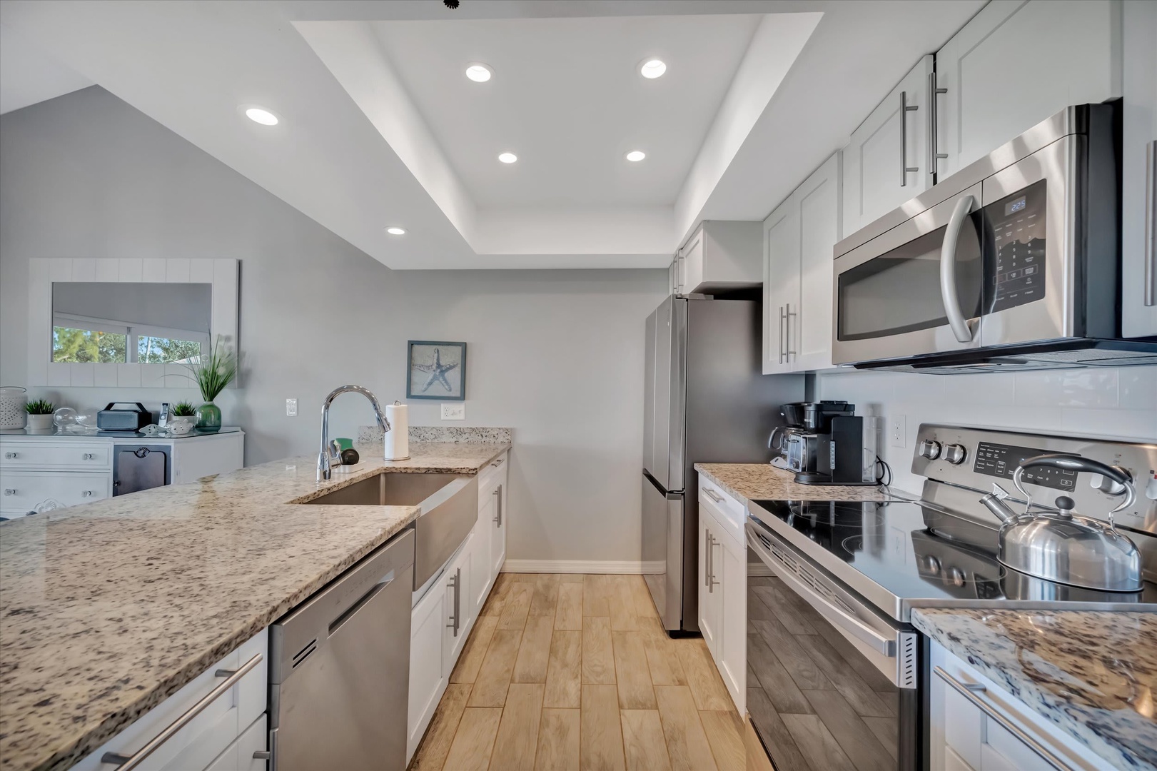 You'll love preparing meals in this bright, modern kitchen with gorgeous granite countertops, stainless steel appliances, and plenty of counter space for your culinary creations.