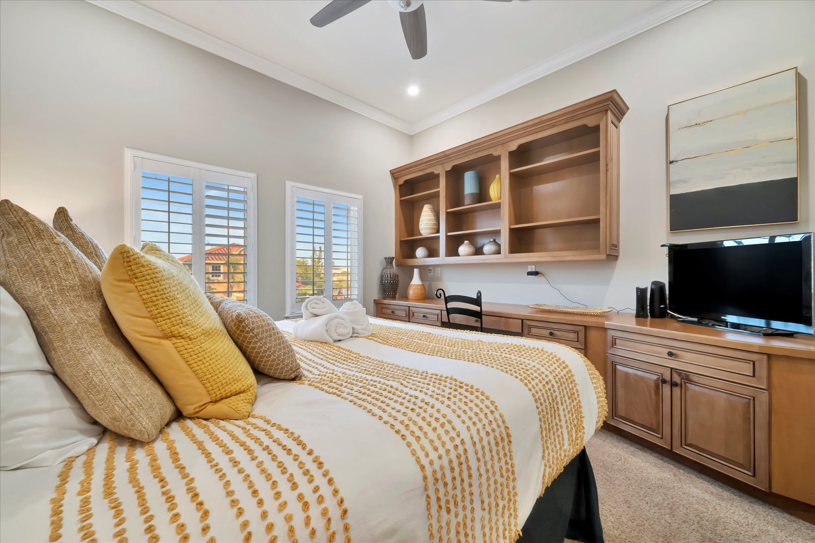 Settle into your comfortable bedroom, where warm wood tones and soft textured linens create a peaceful retreat. A ceiling fan keeps you cool, while built-in storage and your own entertainment center make it easy to unwind.