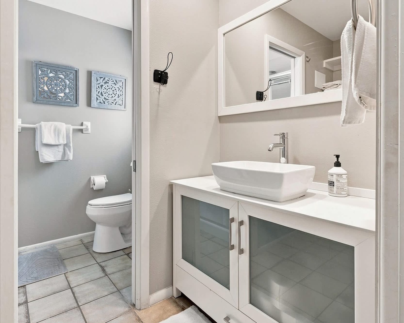 Your private bathroom features a modern vessel sink and fresh towels, with a separate toilet room for added convenience and privacy.