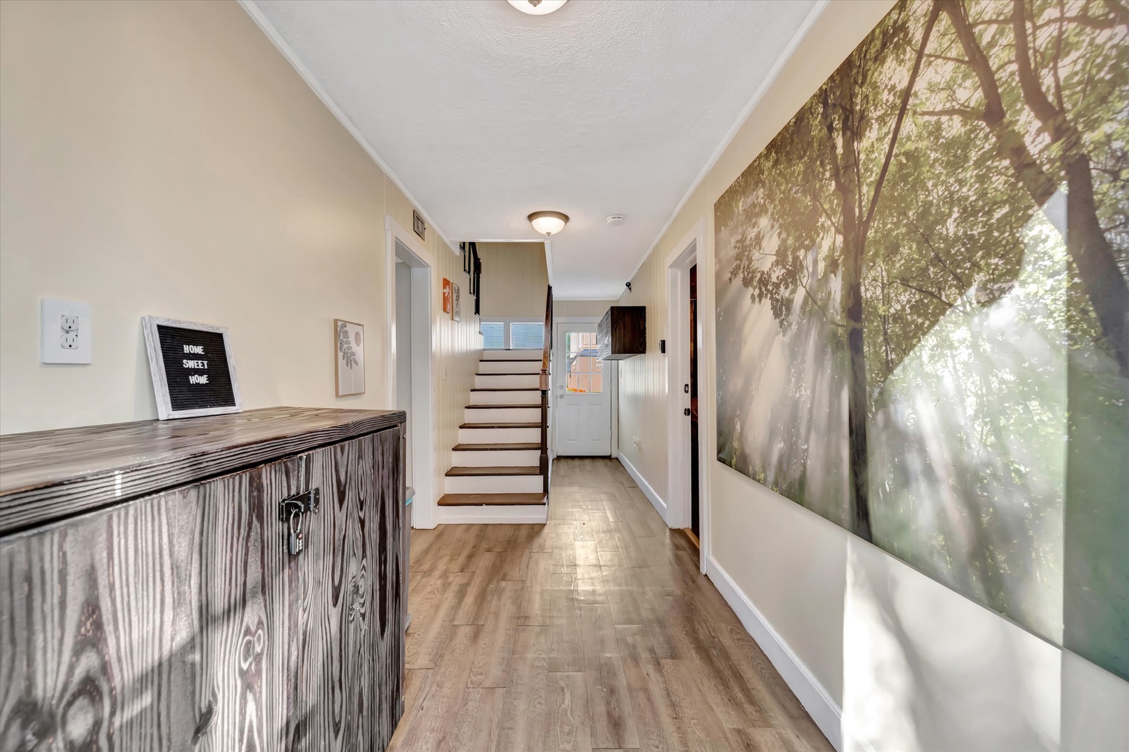 Step into your welcoming hallway, where warm wood tones and thoughtful touches—like the cheerful 'Home Sweet Home' sign—instantly make you feel at home as you arrive.