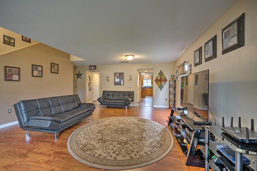 Step into your spacious open living area with gleaming hardwood floors, comfortable convertible sofas, and a welcoming layout perfect for gathering with family and friends during your stay.