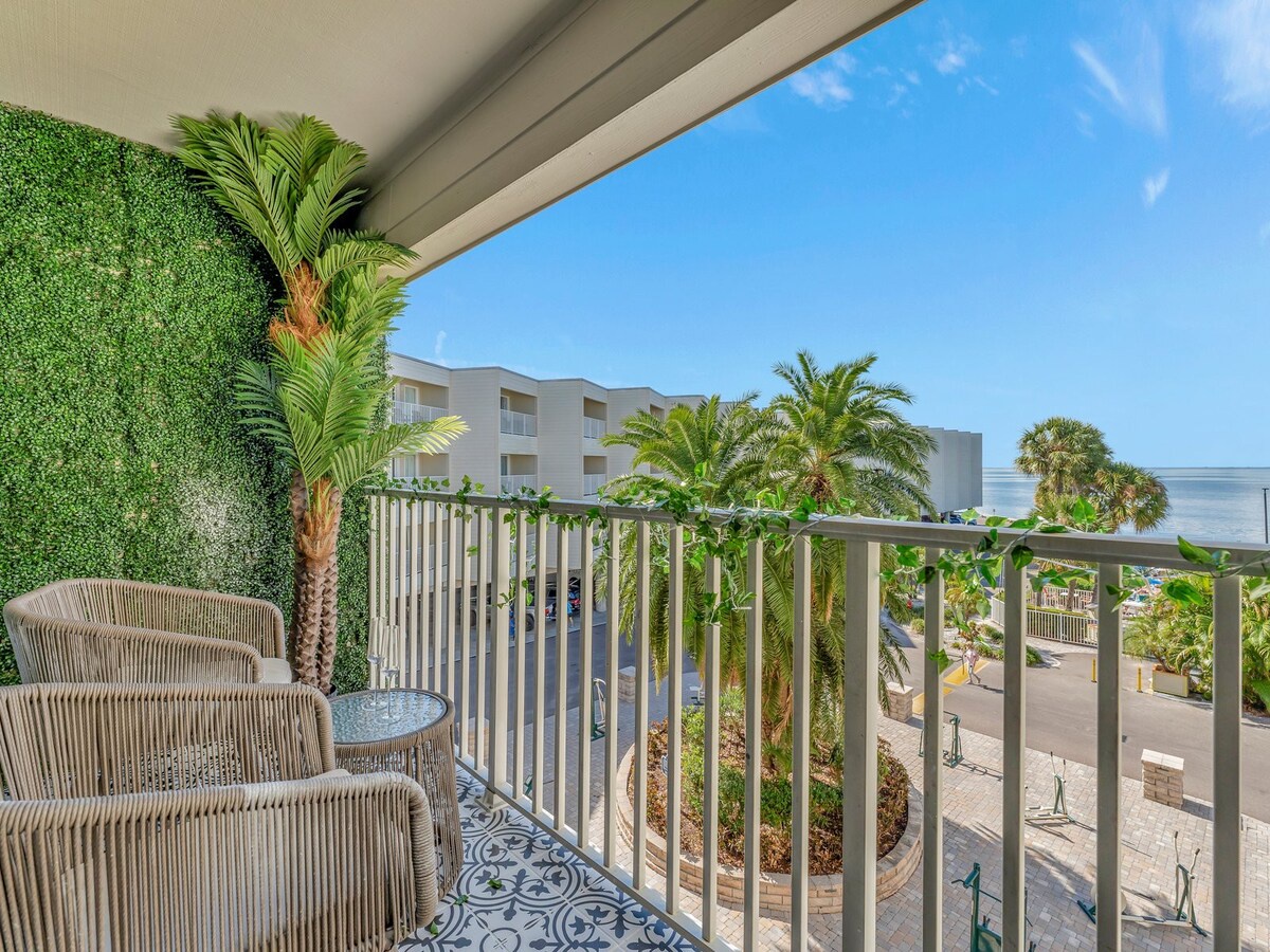 Settle into your cozy balcony seating with tropical palms and ocean breezes—your perfect spot to sip morning coffee or watch the sunset over the water.