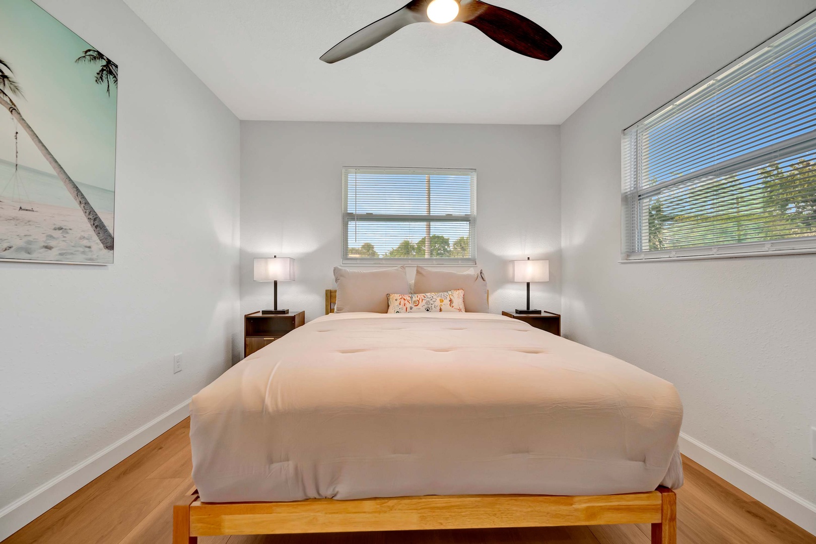Drift off to sleep in your bright, airy bedroom, where soft coastal breezes flow through windows framing lush green views and gentle sunlight welcomes each morning.
