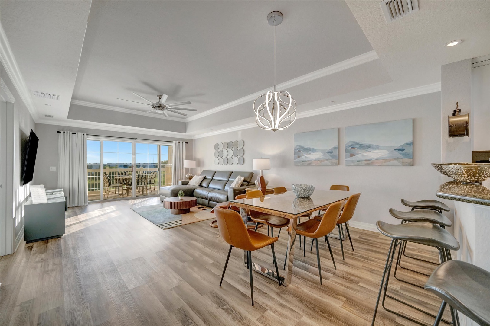 Gather around the dining table or relax on the sofa in this airy, open-plan living space. Natural light fills the room through sliding glass doors leading to your private balcony, where you can step outside and enjoy the view.